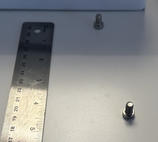 Two bolts at different positions on a table